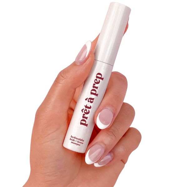 Hand holding Prêt à Prep Hydra Night Lash and Brow Conditioning Masque in white tube for overnight lash and brow hydration and conditioning
