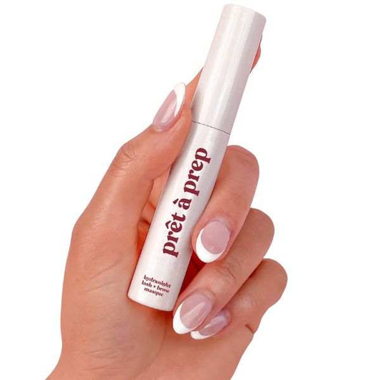 Hand holding Prêt à Prep Hydra Night Lash and Brow Conditioning Masque in white tube for overnight lash and brow hydration and conditioning