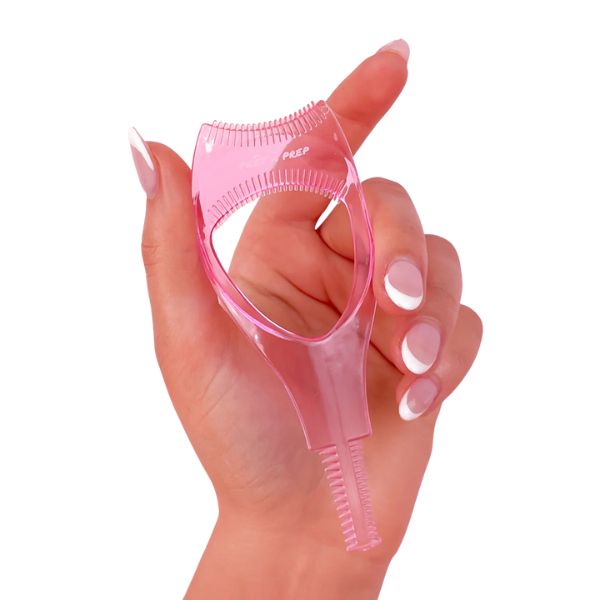 Hand holding pink Prêt à Prep Mascara Shield for smudge-free mascara application and lash extension protection