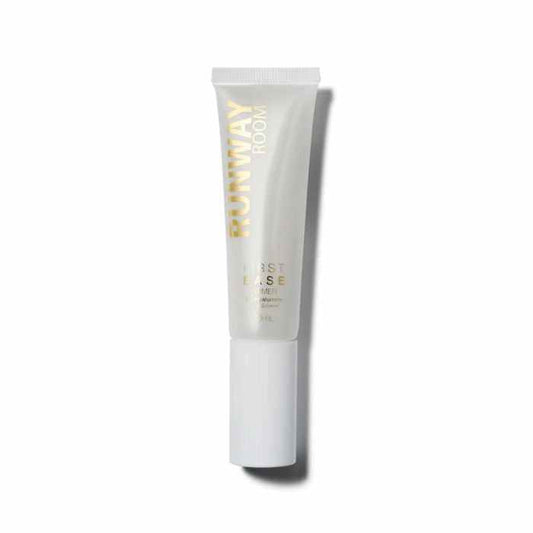 Runway Room First Base Hydrating Primer tube with gold text on white background, hydrating makeup base with hyaluronic acid and natural glow.
