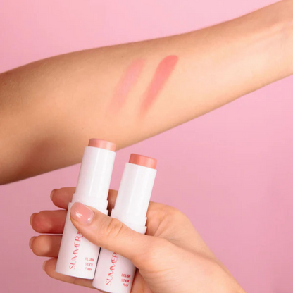 Two Summer & Lu Blush Sticks in peachy shades with matching swatches on arm against pink background
