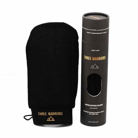 Three Warriors black exfoliating glove with eco-friendly packaging for smooth, radiant skin prepping for self-tanning.